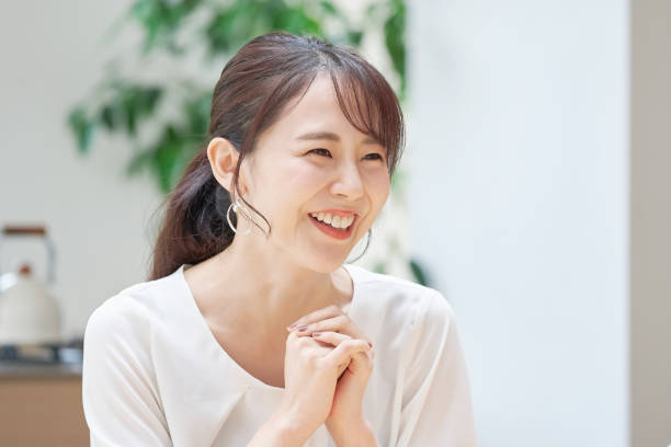 istock Asian woman smiling at home 1293110455