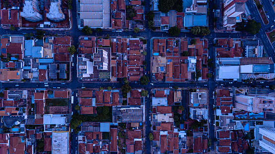 High-altitude aerial capture of buildings and houses in top view.