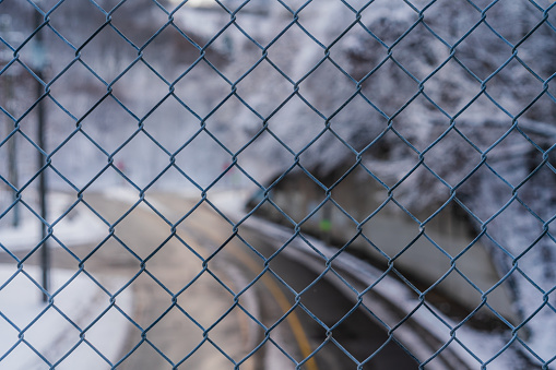 Close up of Chain linked Fence with Street in the Background