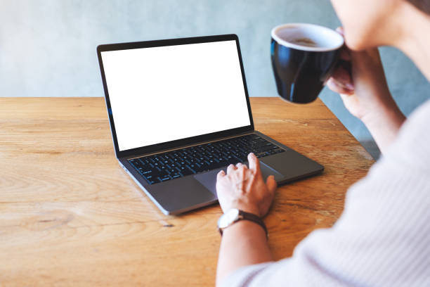 istock a woman using and touching on laptop touchpad with blank white desktop screen while drinking coffee in cafe 1293119107