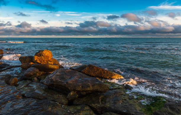 istock Colorful sunrise on the rocky coast 1293125416
