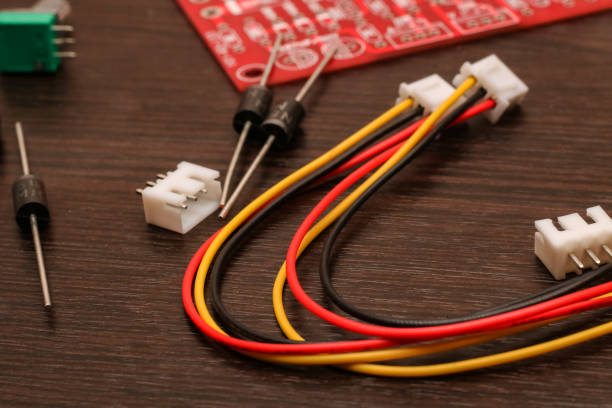 istock Colored wires, resistor and circuit board close-up 1293127694