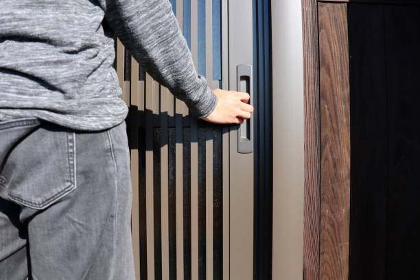 istock A man in jeans trying to open the front door. 1293132226