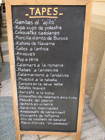 Tapas Menu   Chalkboard Placed on a Restaurant Outdoor Terrace  Spanish gastronomy
