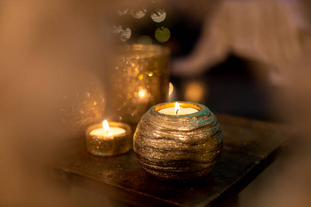 istock Gold candles light arrangement on the wooden table 1293141000
