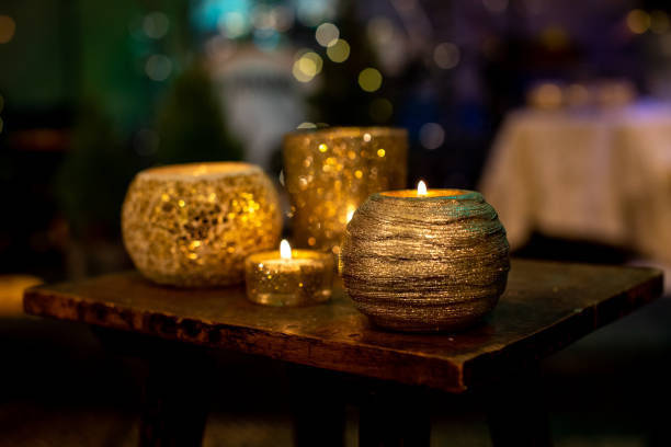 istock Gold candles light arrangement on the wooden table 1293141021