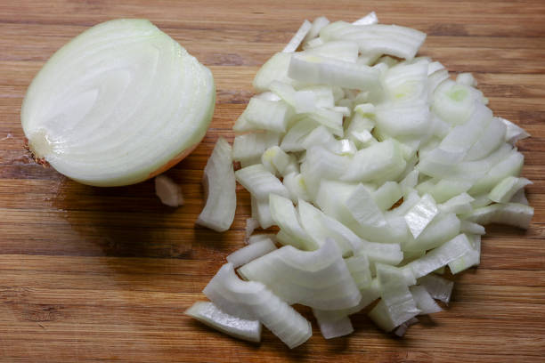 istock Brown Onion being sliced on a chopping board 1293142606
