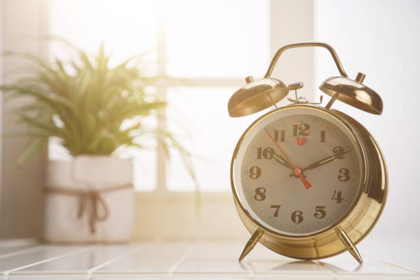 istock vintage alarm clock against window 1293144223