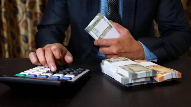 istock Businessman calculating the conversion rate for Indian currency 1293146081