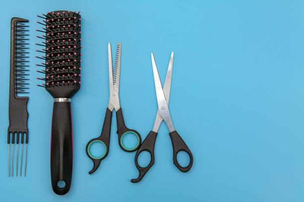istock Hairdressing tools, scissors and comb on colored background, exact copy space 1293147218