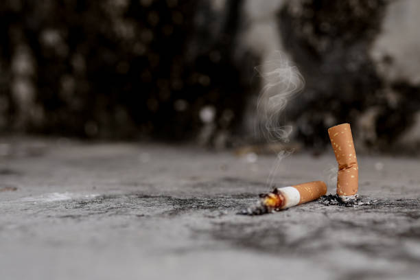 Cigarette butts on the cement floor Concept of toxic waste, not environmentally friendly. Cigarette butts on the cement floor Concept of toxic waste, not environmentally friendly. cigarette fire stock pictures, royalty-free photos & images