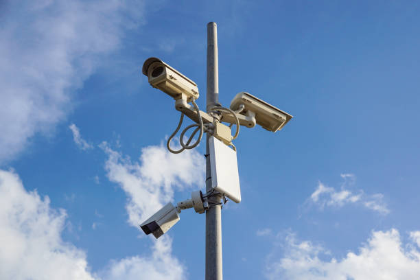 istock Security cctv cameras in front of blue sky 1293148087