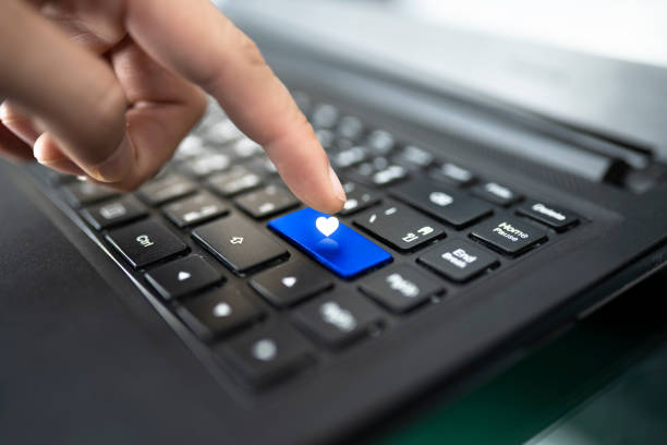 istock laptop keyboard with finger pressing Heart shape key,concept happiness on the internet 1293148088
