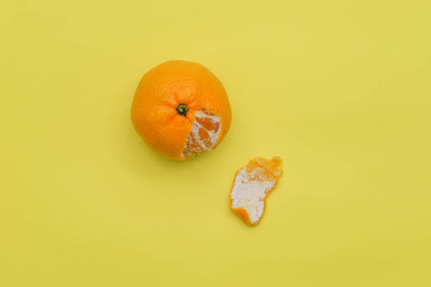 istock Fresh tangerine and peel on a yellow background. Fruit with vitamins. Top view, flat lay 1293152707
