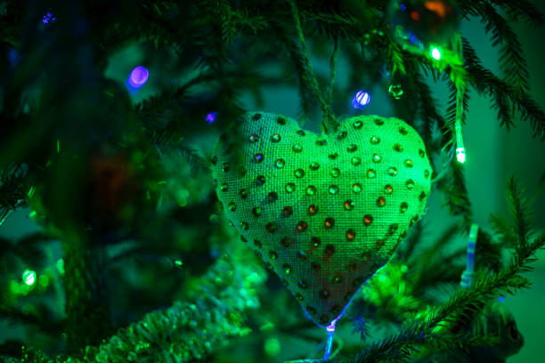 green heart with beads at night green lighting with lanterns, horizontal format