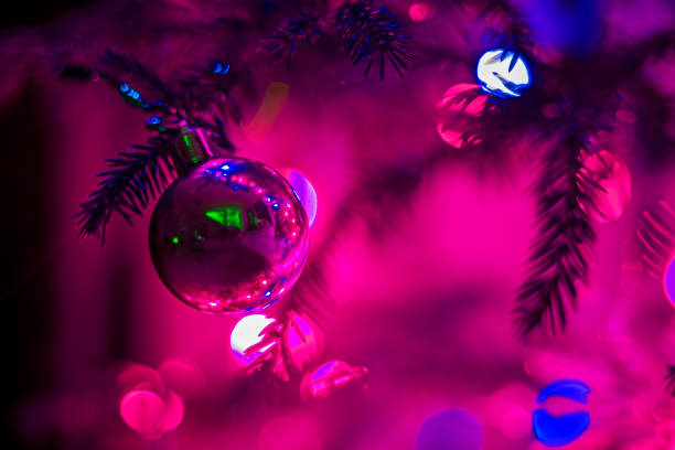 istock Christmas tree crimson ball on a Christmas tree reflects the interior, fluorescent horizontal format 1293153714