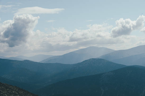 istock Thick clouds over mountain range, hills in blue haze 1293153848