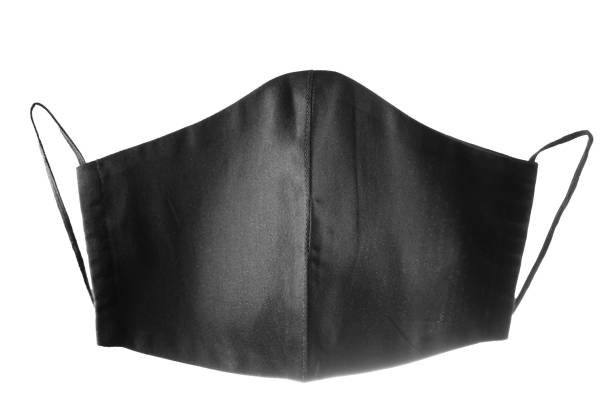istock Face protective mask on white background. Black reusable face mask. Antivirus mask made from black cotton. Isolated 1293158239