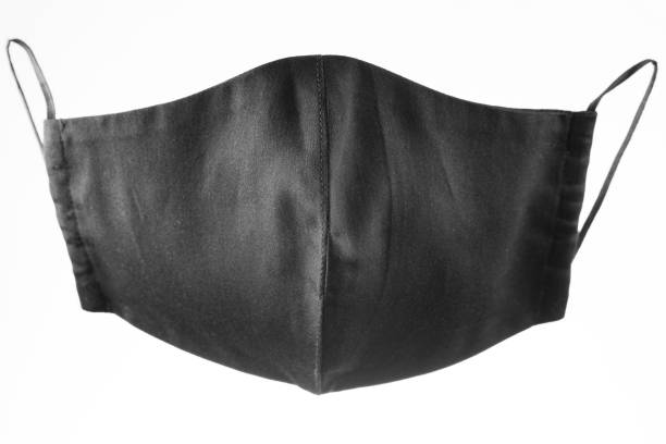 istock Face protective mask on white background. Black reusable face mask. Antivirus mask made from black cotton. Isolated 1293158251
