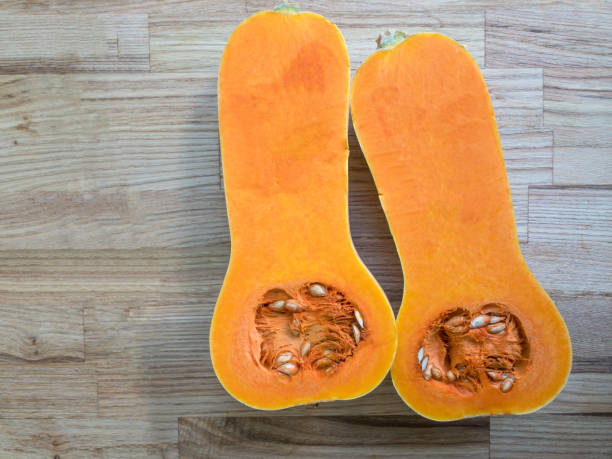 istock Butternut squash halves on a wooden surface 1293158786