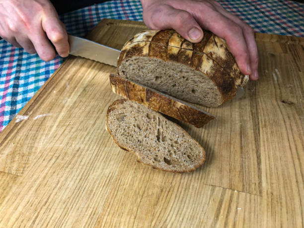 istock Slicing a whole wheat sourdough bread 1293158835