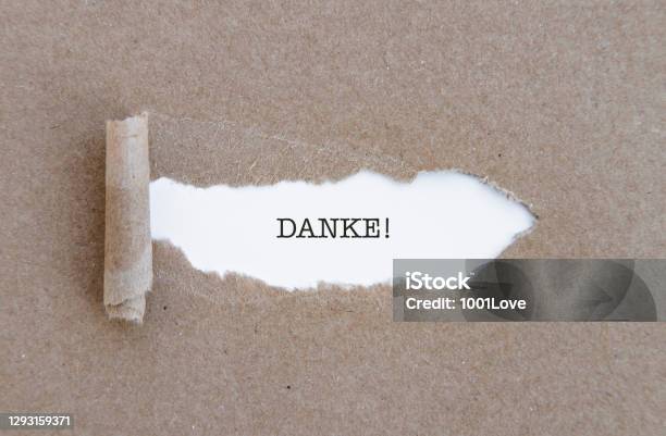 Thank You In German Danke Word Written Under Torn Paper Stock Photo - Download Image Now