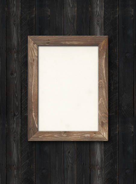istock Old rustic wooden picture frame hanging on a black wall. Horizontal picture 1293160548