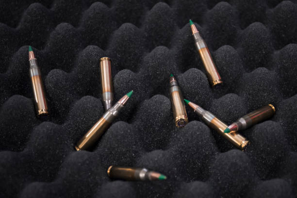 Close-up 5.56 m855 62gr green tip bullets lying on protective black foam