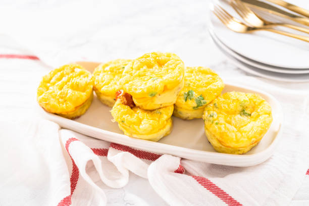 istock Bacon and cheese egg muffin on a white serving plate. 1293161737