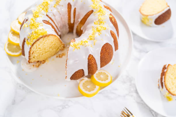 istock Sliced lemon bundt cake decorated with lemon zest on a cake stand. 1293163270