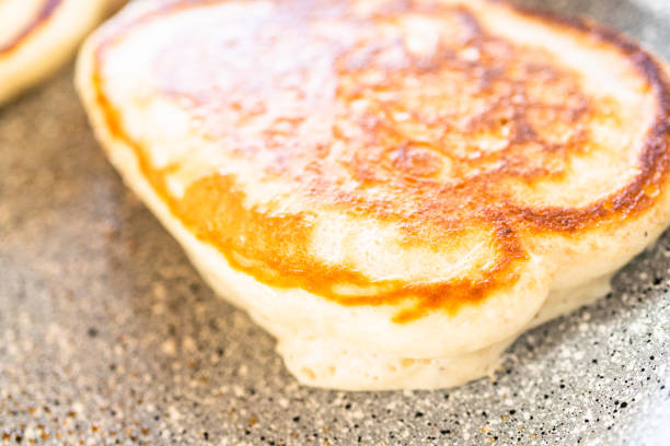 istock Frying kefir based pancakes in cooking pan on an electric stove. 1293163462