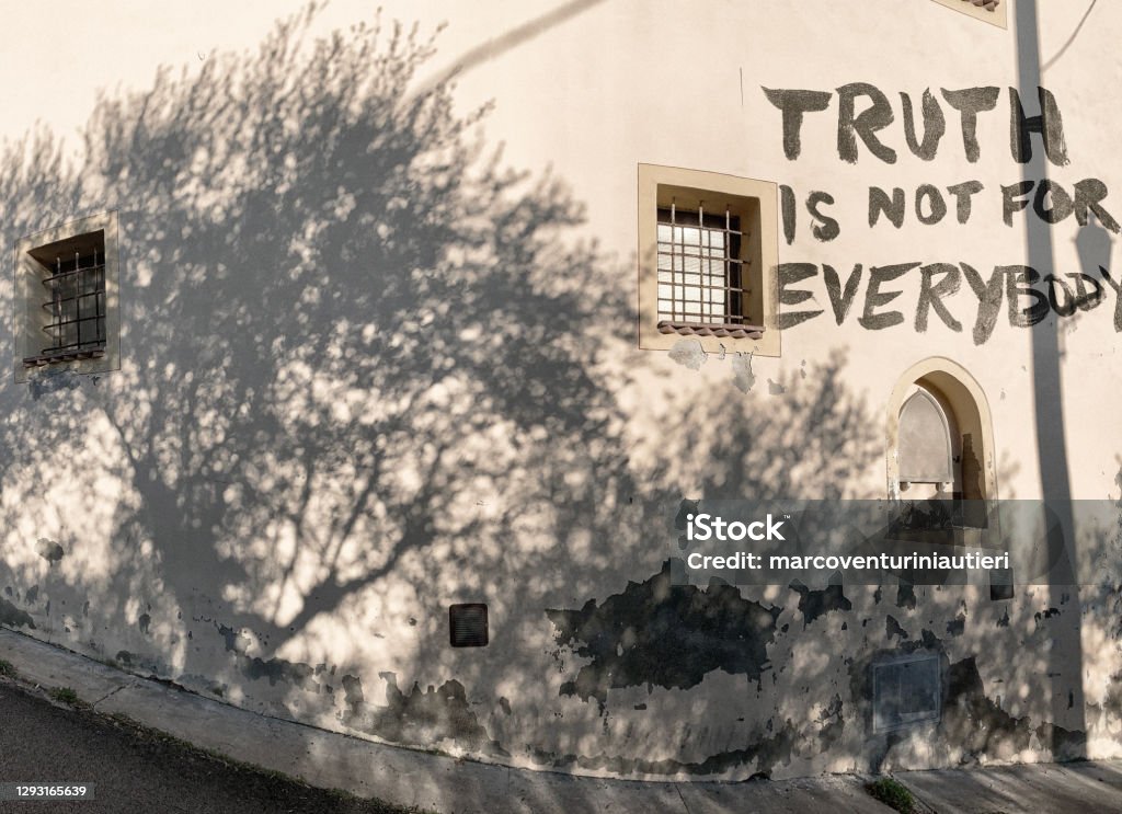 truth is not for everybody "Truth is not for everybody" is written on a residential wall with a graffiti. *** The artwork was digitally superimposed and a release is provided *** Misinformation Stock Photo