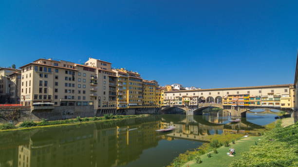 istock View on The Ponte Vecchio on a sunny day timelapse , a medieval stone segmental arch bridge over the Arno River, in Florence, Italy 1293167026