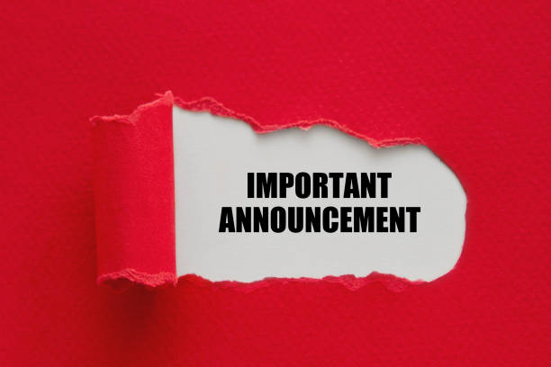 istock Important announcement written under torn paper. 1293168940