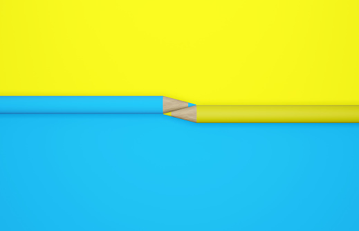 Yellow and blue pencils on a yellow and blue background. Concept And Idea