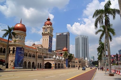 People walking on Merdeka square by the majestic Sultan Abdul Samad palace, Kuala Lumpur