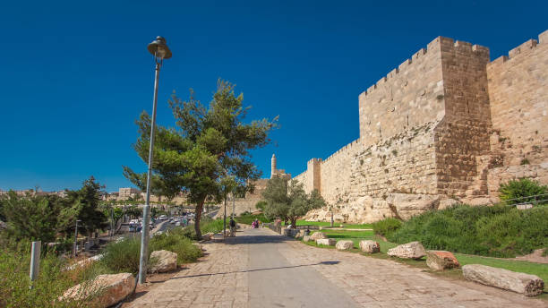 istock Defensive wall of the ancient holy Jerusalem timelapse hyperlapse, lit by the bright sun. Wonderful green lawn 1293176621
