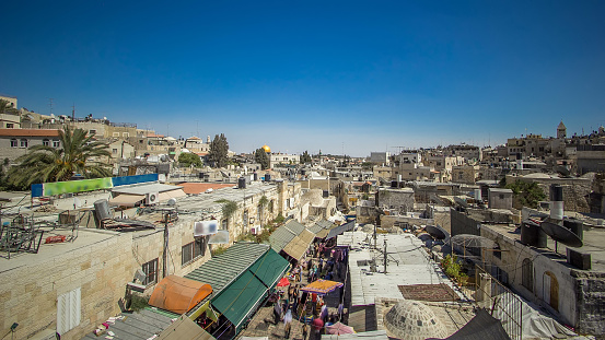 View from the top of Damascus gate to Jerusalem Old Town timelapse. Israel. Blue cloudy sky, walking people and traffic on the road