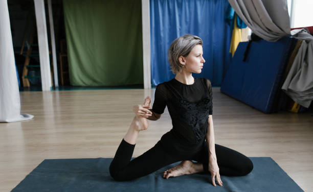 istock Yoga exercises in an empty yoga studio, quarantine time 1293180232