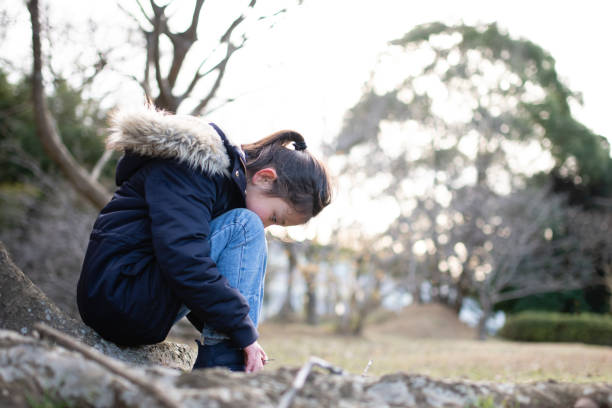 Girl sitting and looking down