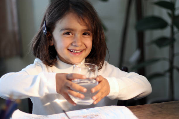 cute girl drinking a glass of water