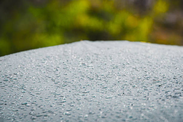 Dew drops on green tourist tent. Waterproof fabric rain, test of bad weather stock photo