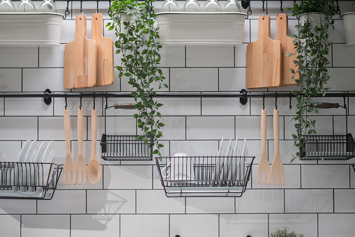 Kitchenware hanging on the wall of the modern kitchen.