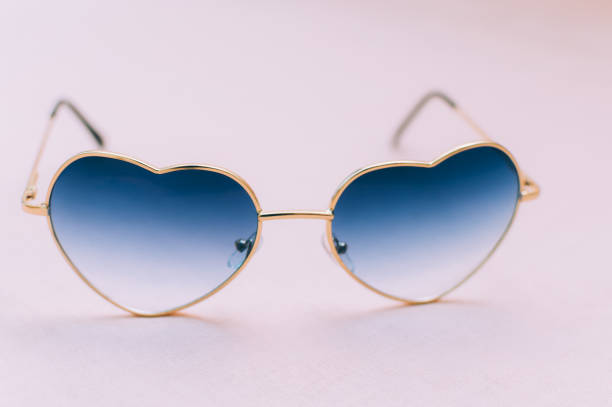 istock Heart shaped sunglasses on pink background close up 1293189378