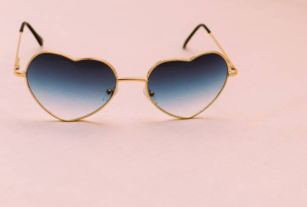 istock Heart shaped sunglasses on pink background 1293189395
