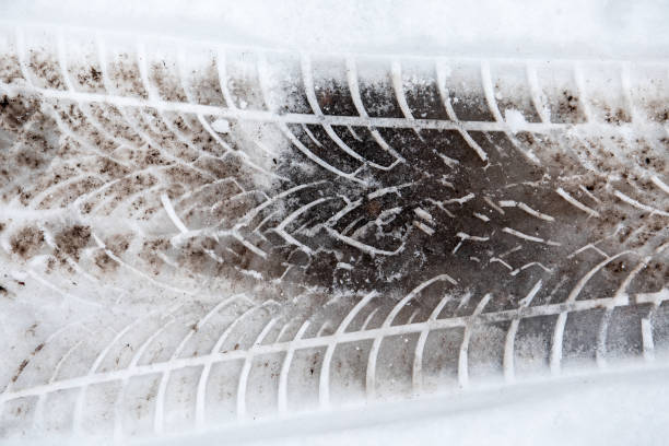 istock Tire print on a roads after snowfall in winter. Muddy snow 1293191243
