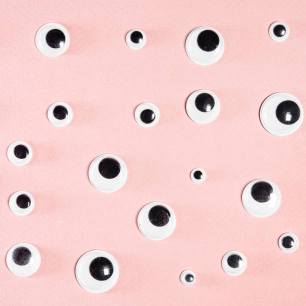 istock many self-adhesive doll eyes on square pink paper 1293191260