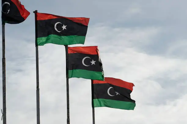 The flag of Libya was originally introduced in 1951, following the creation of the Kingdom of Libya. The flag, consisting of the Pan Arab colours, was designed by Omar Faiek Shennib and approved by King Idris Al Senussi who comprised the UN delegation representing the three regions of Cyrenaica, Fezzan, and Tripolitania at UN unification discussions.