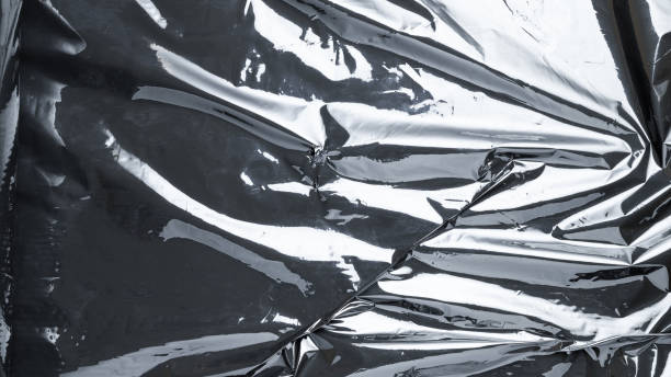 istock Plastic texture. Wrap transparent dark cellophane background. Black shiny film bag pattern. Real texture of polyethylene foil. 1293196471