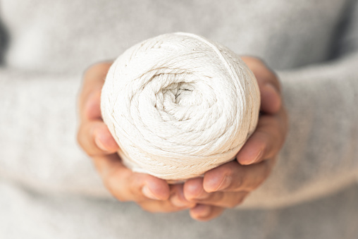 Woman holding a ball of wool.